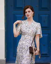 a lady wears a silk v-neck floral printed dress